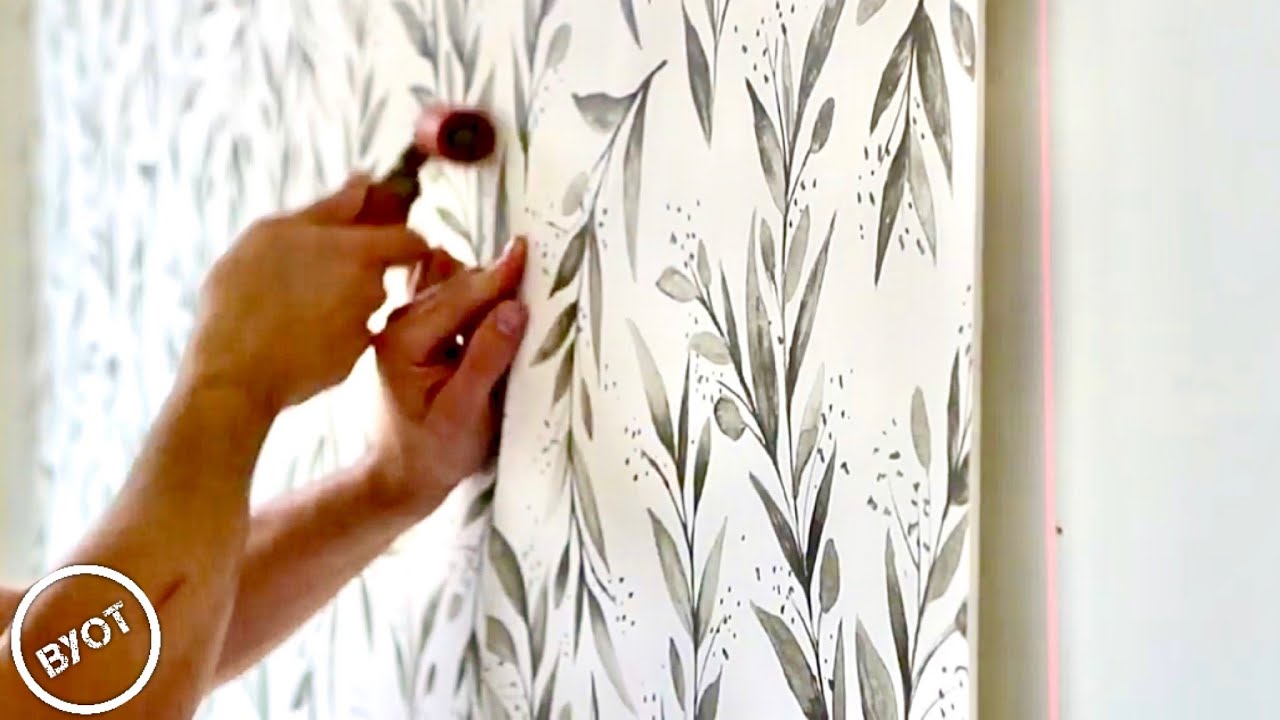 Wallpaper installation tools and patterned wallcovering in progress
